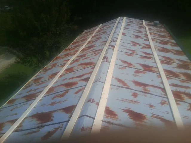 Rusted metal roof panels with new wood purlins before replacement — Storm Damage Roof Repair in Bayard by Roofing Brothers